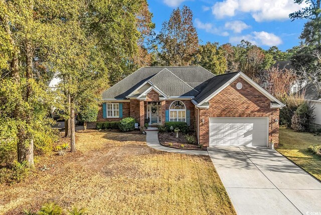 view of front of property featuring a garage and a front yard