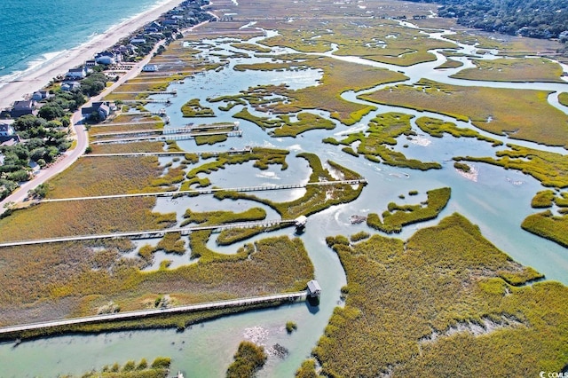 birds eye view of property featuring a view of the beach and a water view