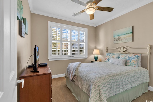 carpeted bedroom with ceiling fan and ornamental molding