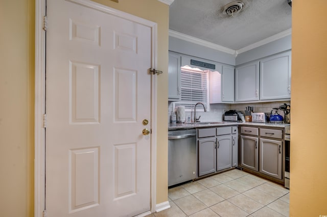 kitchen with sink, stainless steel dishwasher, light tile patterned floors, ornamental molding, and tasteful backsplash