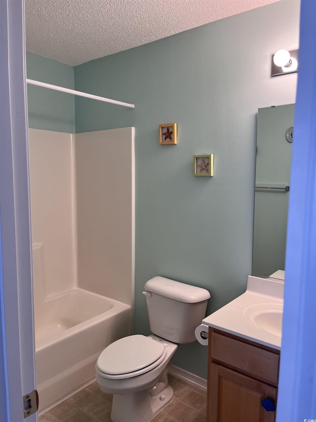 full bathroom featuring vanity,  shower combination, tile patterned floors, toilet, and a textured ceiling