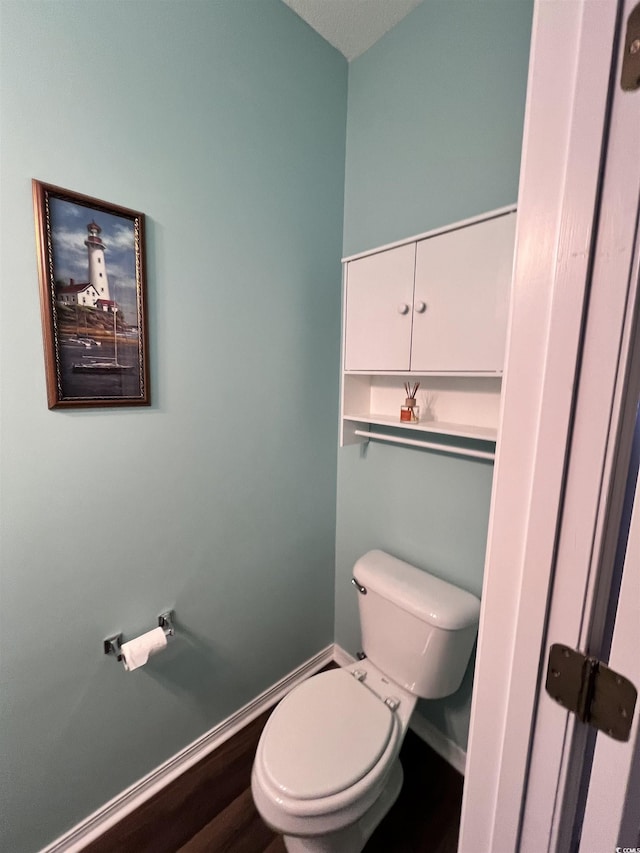 bathroom featuring hardwood / wood-style floors and toilet