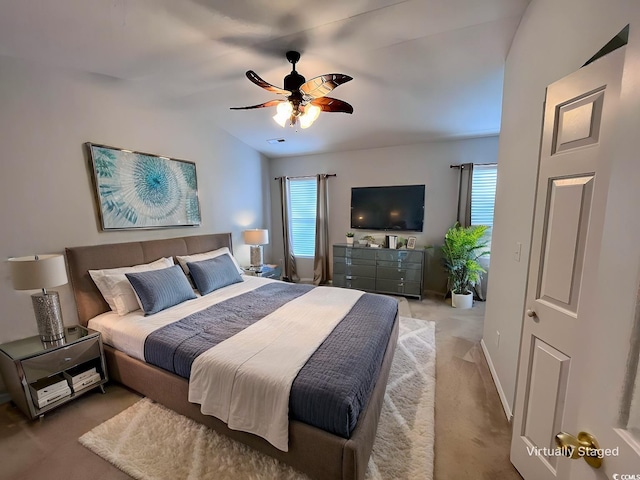 carpeted bedroom featuring ceiling fan and lofted ceiling