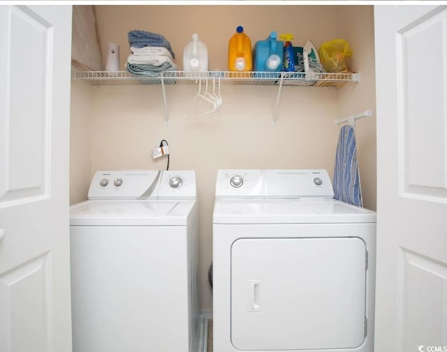 clothes washing area featuring washing machine and dryer