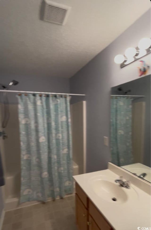 bathroom with vanity and a shower with shower curtain