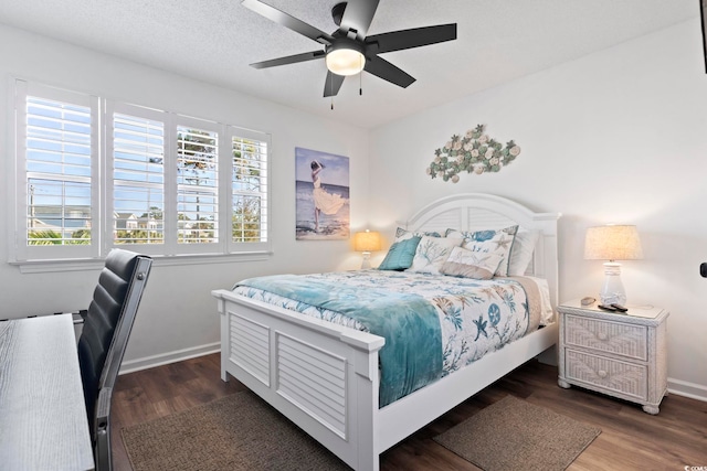 bedroom with a textured ceiling, dark hardwood / wood-style flooring, and ceiling fan