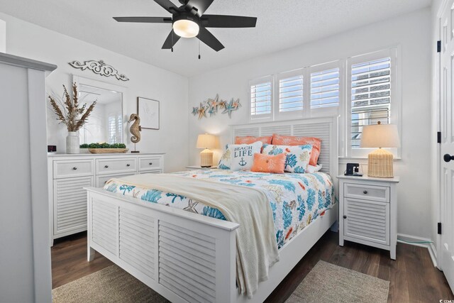 bedroom with a textured ceiling, dark hardwood / wood-style floors, and ceiling fan