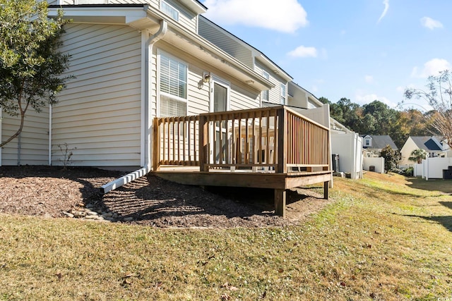 view of home's exterior with a lawn, a wooden deck, and central AC unit