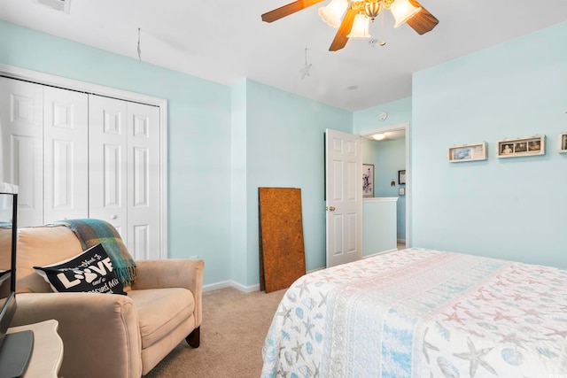 bedroom featuring light carpet, a closet, and ceiling fan