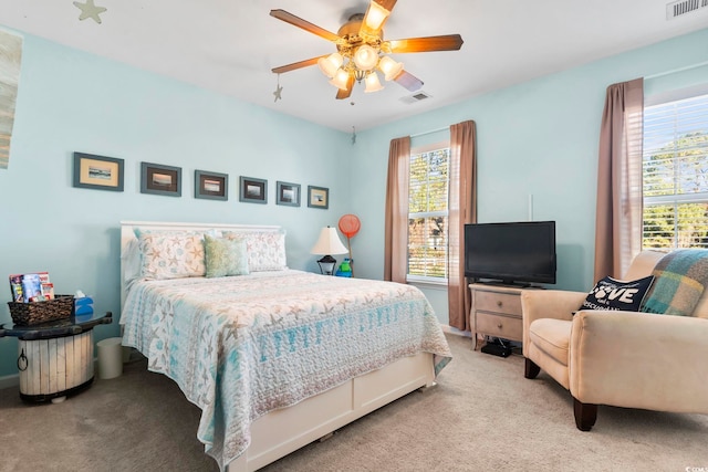 bedroom with carpet, multiple windows, and ceiling fan