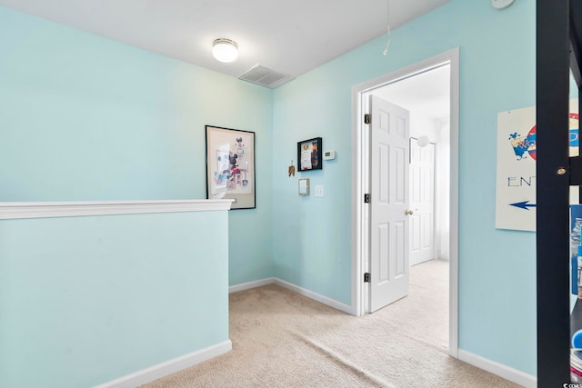 corridor with light colored carpet