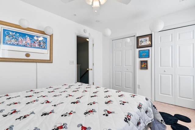 carpeted bedroom with multiple closets and ceiling fan