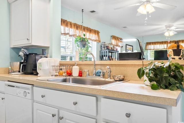 kitchen with dishwasher, white cabinetry, sink, and a wealth of natural light