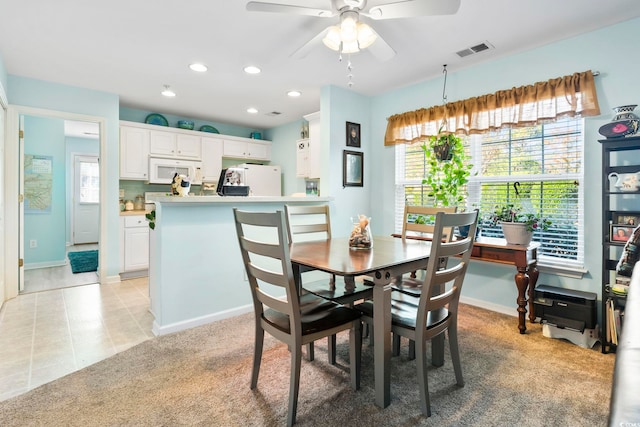 dining area featuring ceiling fan and light tile patterned floors