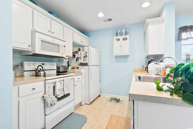 kitchen featuring white cabinets, decorative backsplash, white appliances, and sink