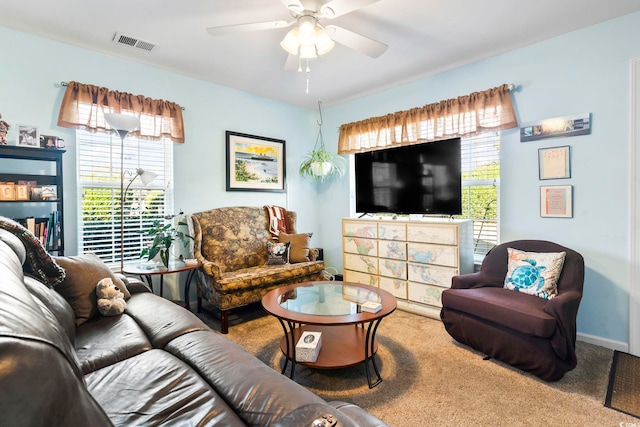 carpeted living room with ceiling fan