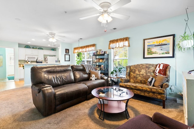 living room featuring light carpet and ceiling fan