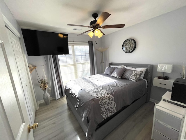 bedroom with a closet, ceiling fan, and hardwood / wood-style floors