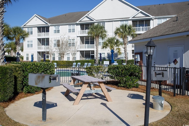 view of home's community featuring a patio area and a pool