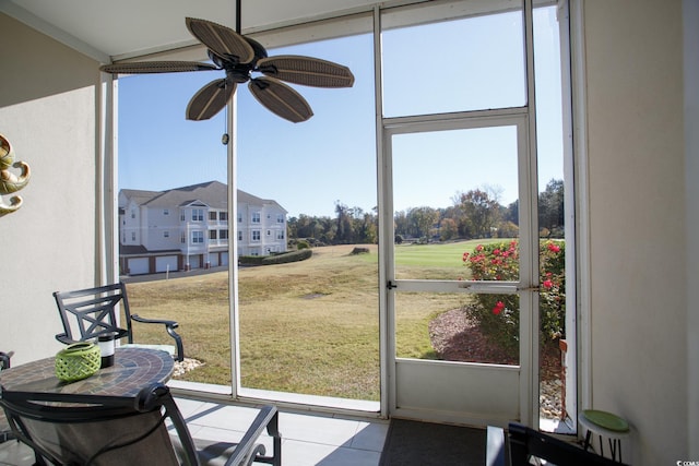 sunroom / solarium featuring ceiling fan and a healthy amount of sunlight