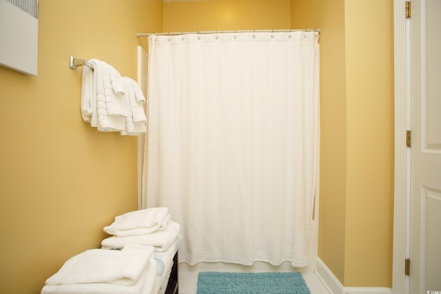 bathroom with shower / bath combination with curtain