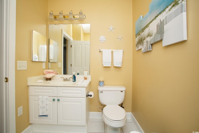 bathroom with tile patterned floors, vanity, and toilet