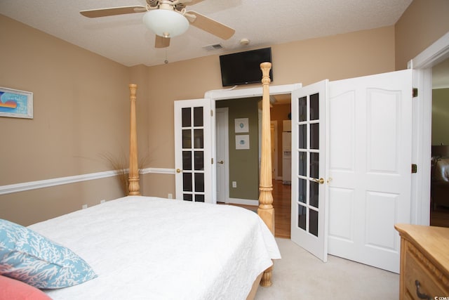 bedroom with light carpet, french doors, ceiling fan, a textured ceiling, and white fridge