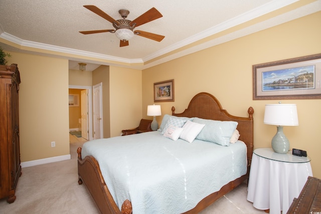 carpeted bedroom with ceiling fan, ensuite bathroom, a textured ceiling, and crown molding