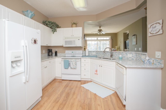 kitchen featuring ceiling fan, sink, white appliances, white cabinets, and light wood-type flooring