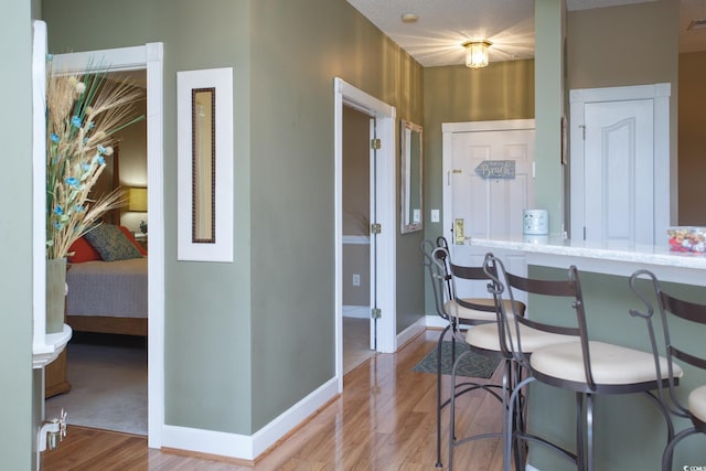 kitchen featuring light stone countertops and wood-type flooring