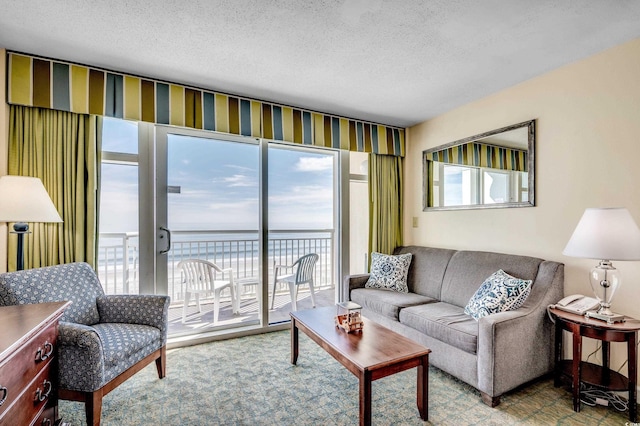 living room with a water view and a textured ceiling