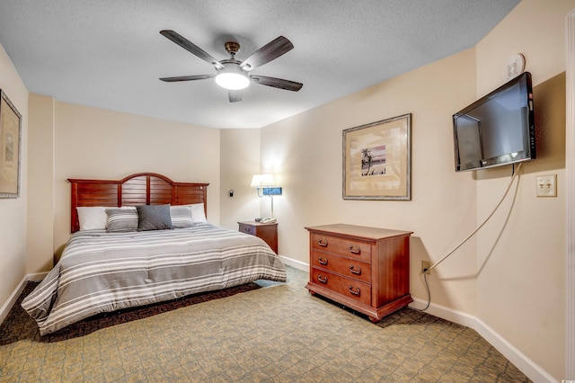 bedroom with ceiling fan and a textured ceiling