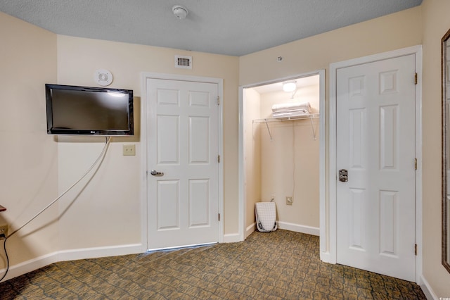 unfurnished bedroom featuring a closet and a textured ceiling