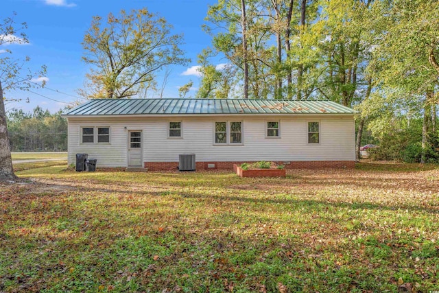 back of property featuring a yard and central air condition unit