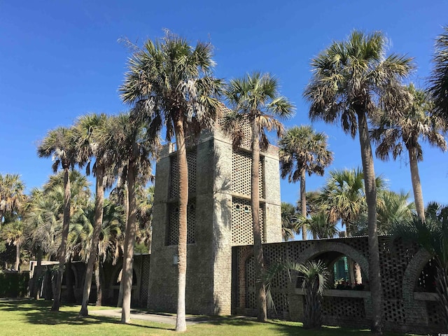 view of side of home featuring a lawn