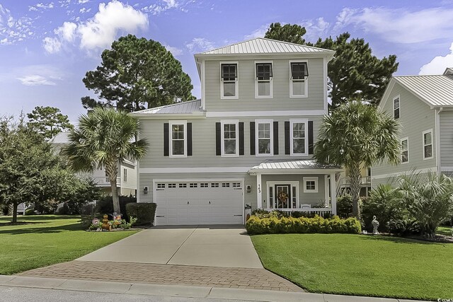 view of front of property with a porch, a garage, and a front yard