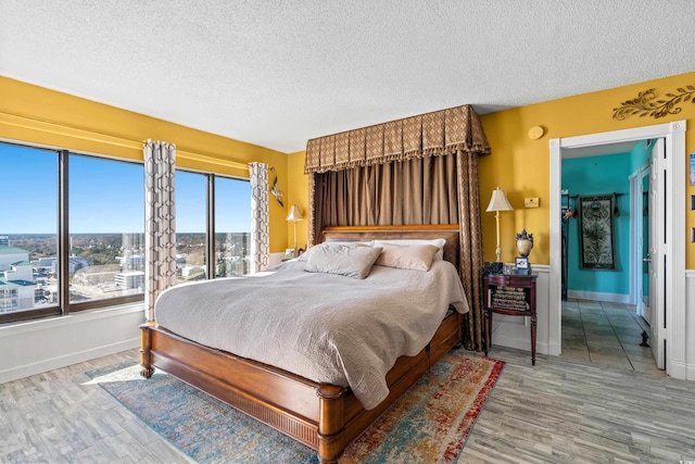 bedroom featuring wood-type flooring and a textured ceiling