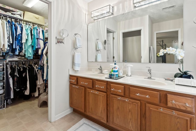 bathroom with vanity and a textured ceiling