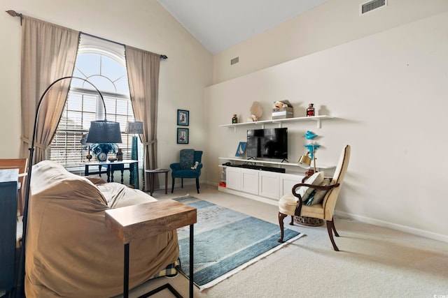 carpeted living room featuring lofted ceiling