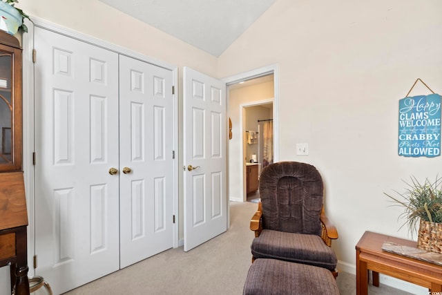 living area with light colored carpet and lofted ceiling