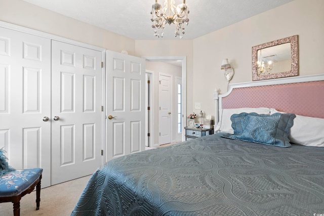 bedroom with light carpet and a chandelier