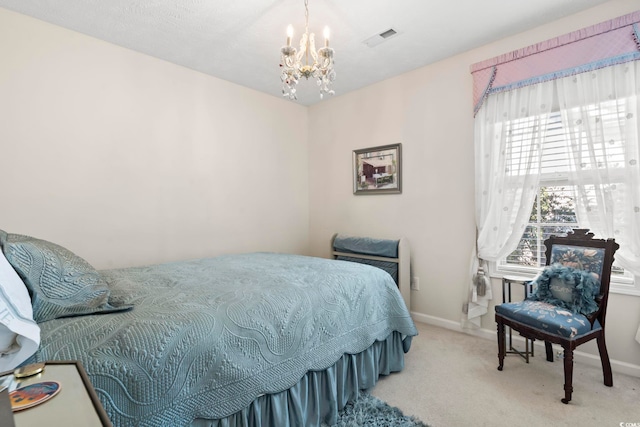 bedroom featuring light colored carpet and a chandelier