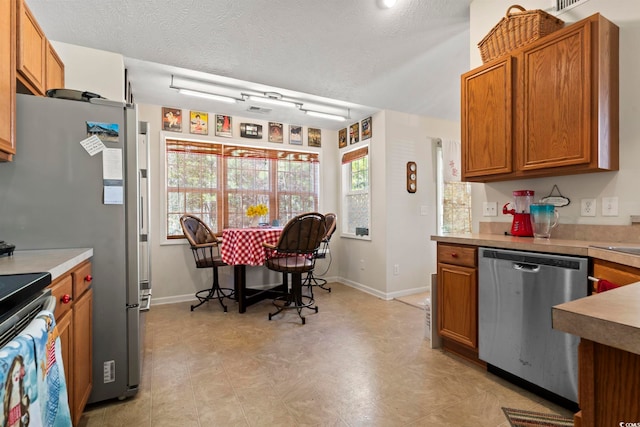 kitchen featuring a textured ceiling and appliances with stainless steel finishes