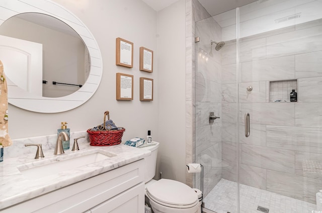 bathroom with vanity, toilet, and walk in shower