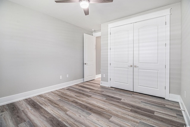 1201 Surf Pointe Dr, North Myrtle Beach, SC 29582 - unfurnished bedroom featuring wood finished floors, baseboards, a closet, and a ceiling fan