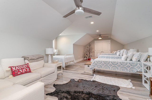 bedroom with light hardwood / wood-style floors, ceiling fan, and lofted ceiling