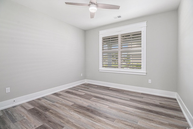 1201 Surf Pointe Dr, North Myrtle Beach, SC 29582 - empty room with wood finished floors, ceiling fan, and baseboards