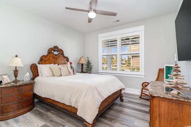 bedroom featuring ceiling fan and dark wood-type flooring