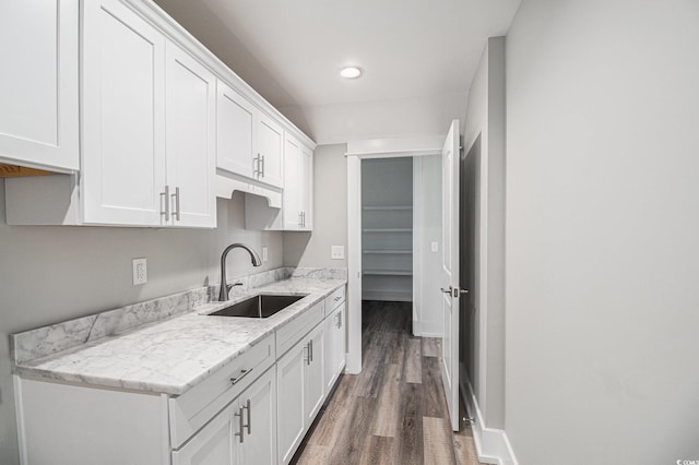 1201 Surf Pointe Dr, North Myrtle Beach, SC 29582 - kitchen featuring a sink, wood finished floors, white cabinets, recessed lighting, and light stone counters