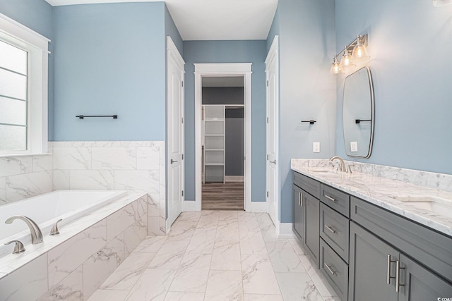 1201 Surf Pointe Dr, North Myrtle Beach, SC 29582 - bathroom with marble finish floors, a walk in closet, a bath, baseboards, and double vanity